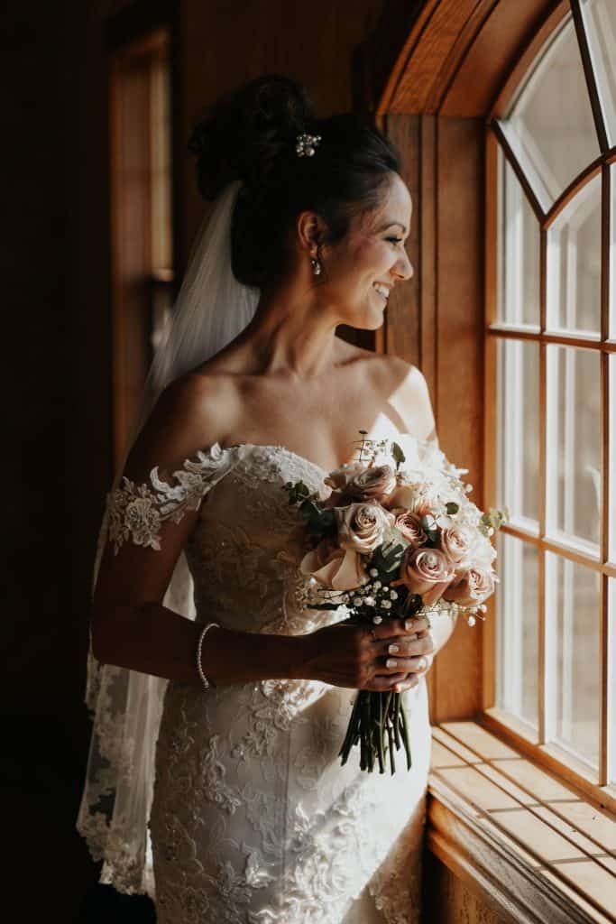 a woman smiling in her wedding dress