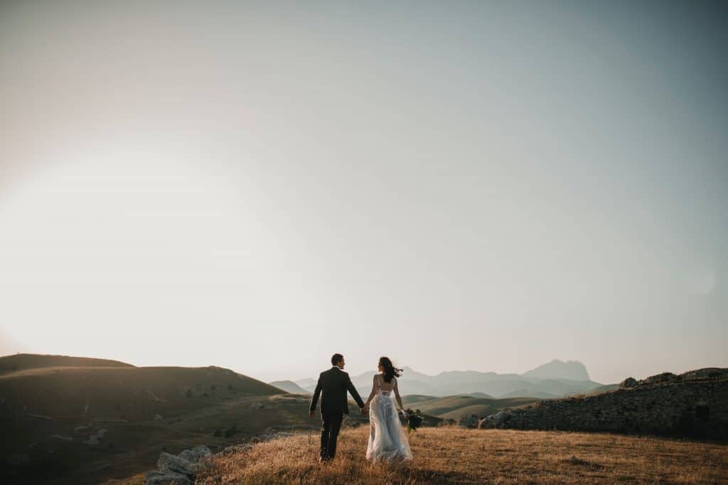 A picture of a couple heading into a wide open plain