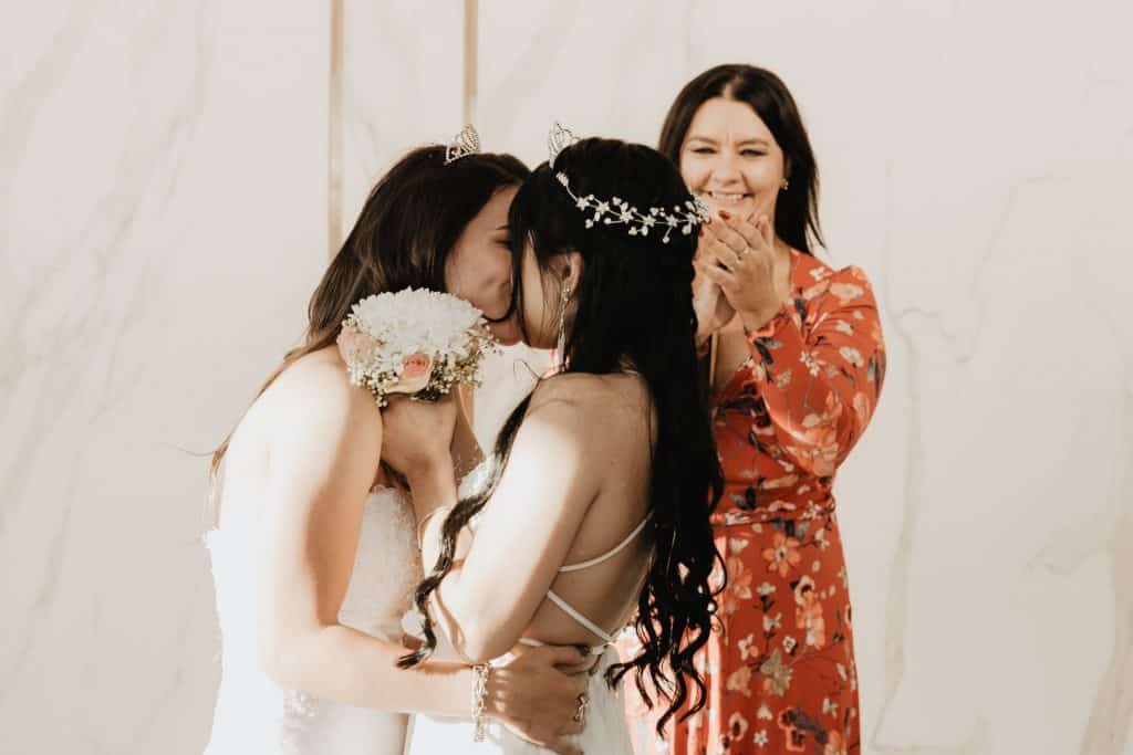 photo of two brides kissing
