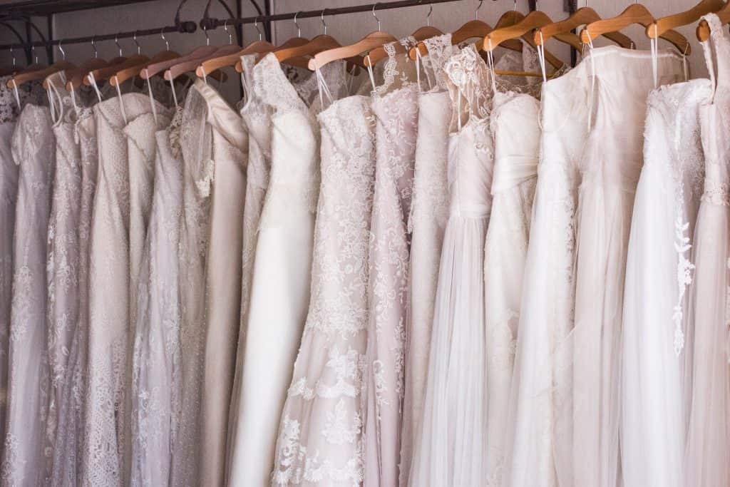 wedding dresses hanging on a rack
