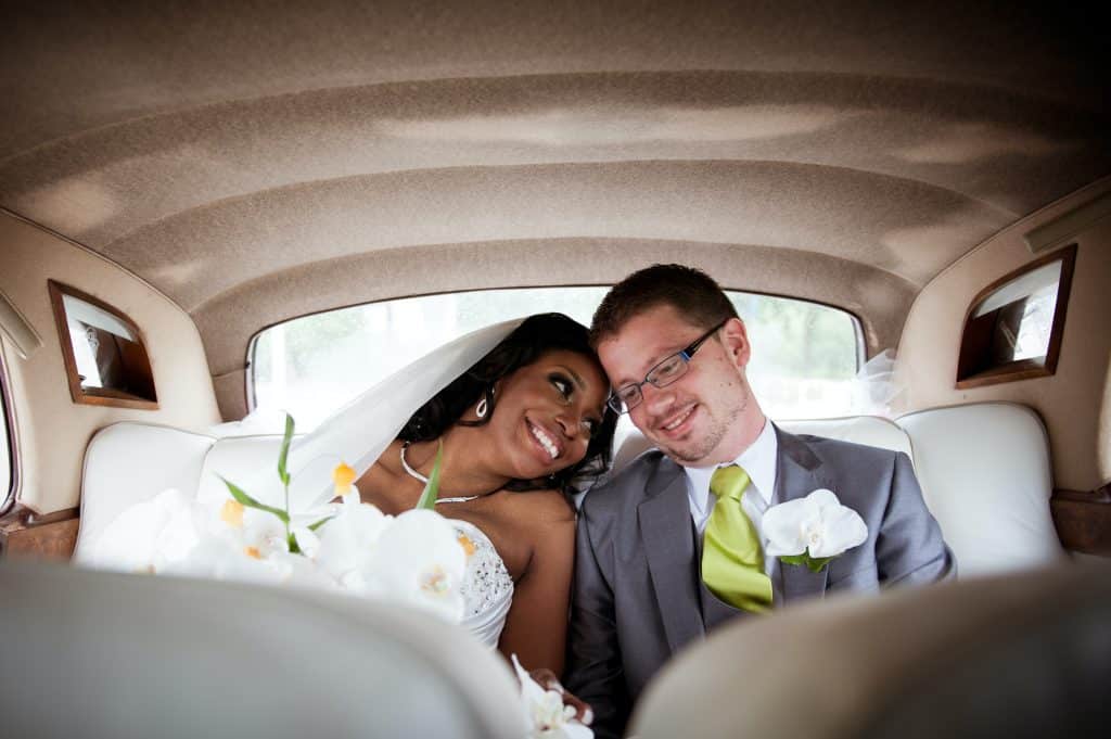 a bride and a groom in a car happily married