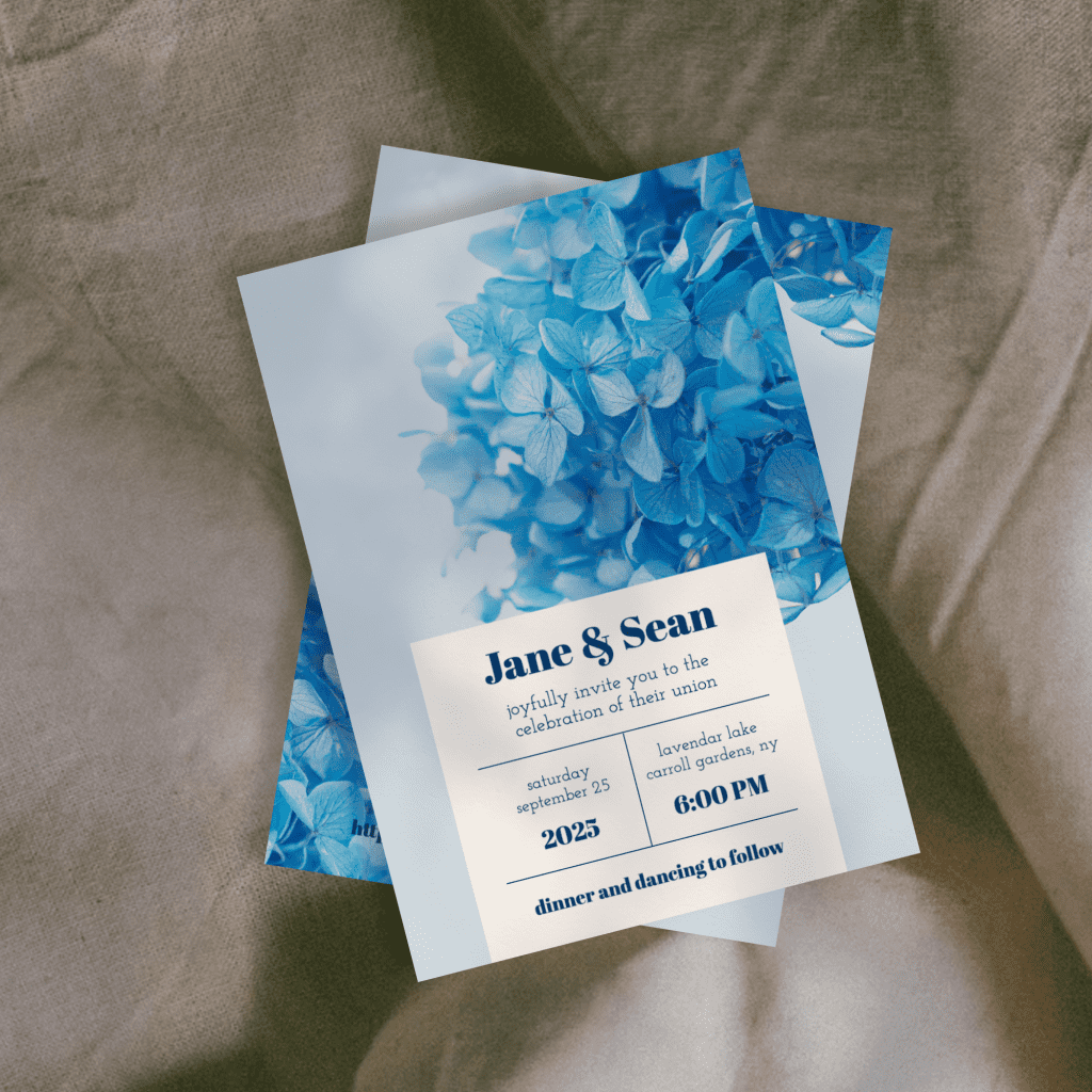 dusty blue hydrangea wedding invitation on a grey background