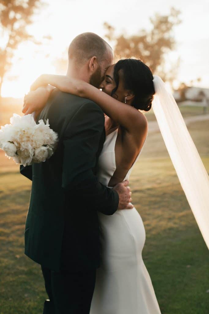 a photo of a bride and groom hugging