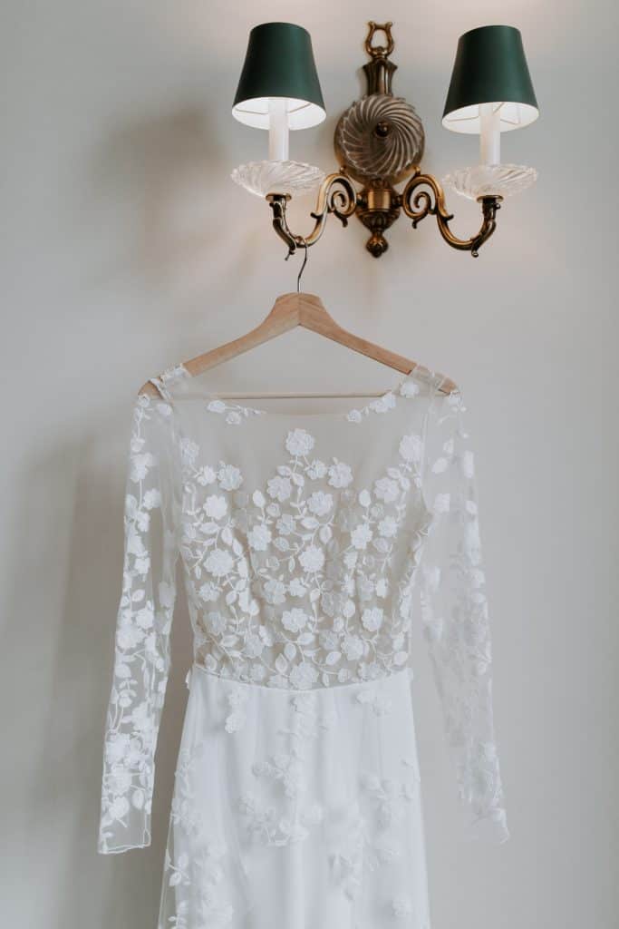 a lace wedding dress on a hanger