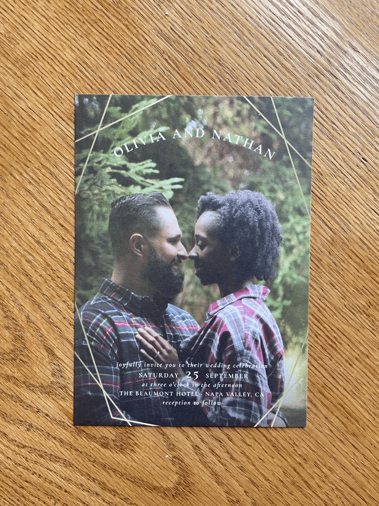wedding invitation with a photo of a couple on a wood background
