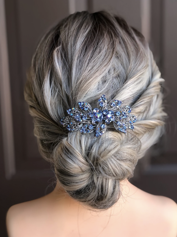 a women with a blue hair clip in her hair for a wedding