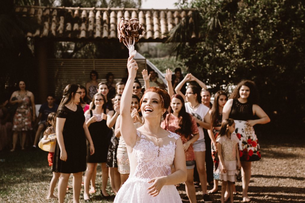 bride throwing a bouquet in an amateur wedding photo