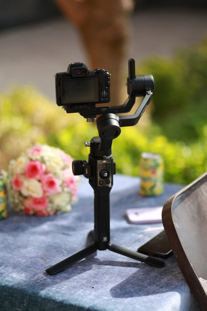 tripod set up with a camera at a wedding