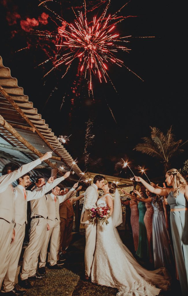photo of a bride and groom with a fireworks display and sparklers