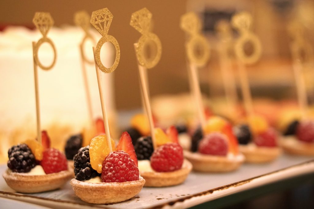 fruit tart desserts with an engagement ring topper