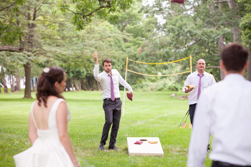 husband and wife playing lawn games during wedding cocktail hour