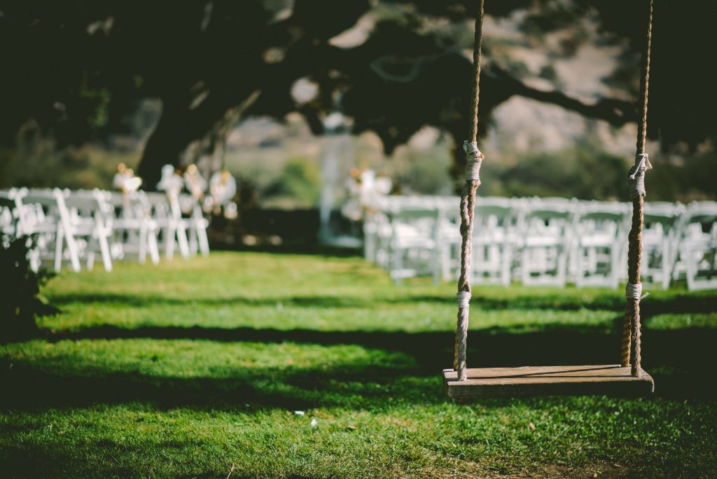 swing in front of a wedding ceremony chair set up