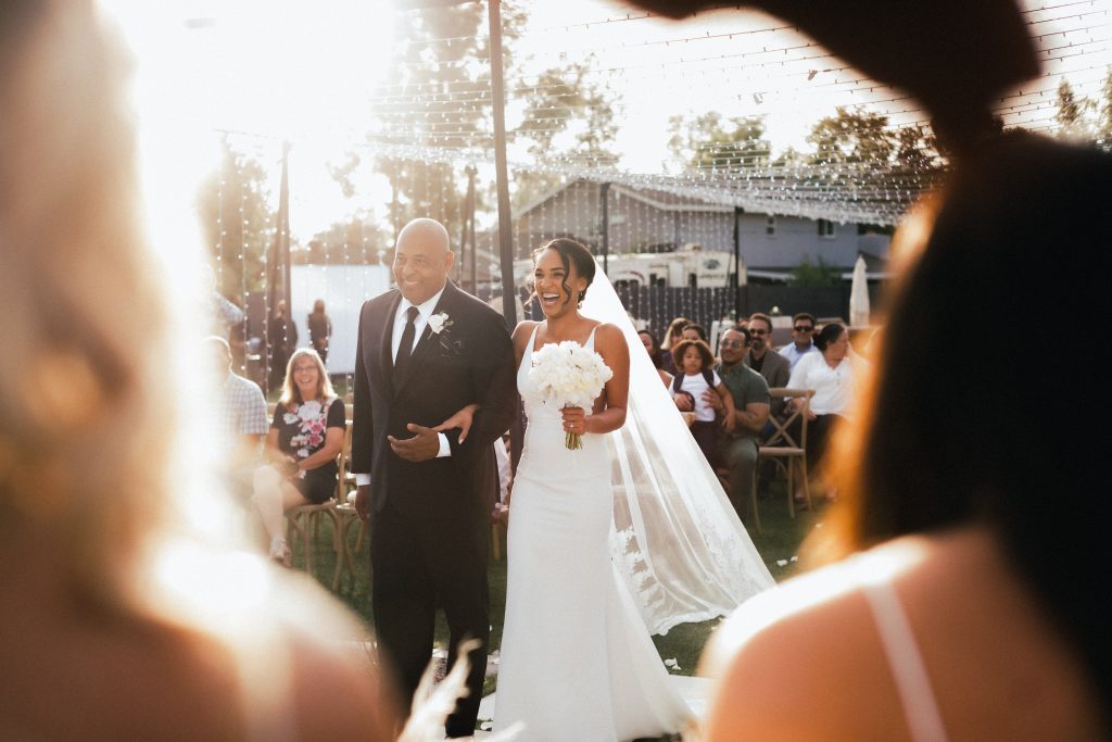 dad walking bride down the aisle at a backyard wedding