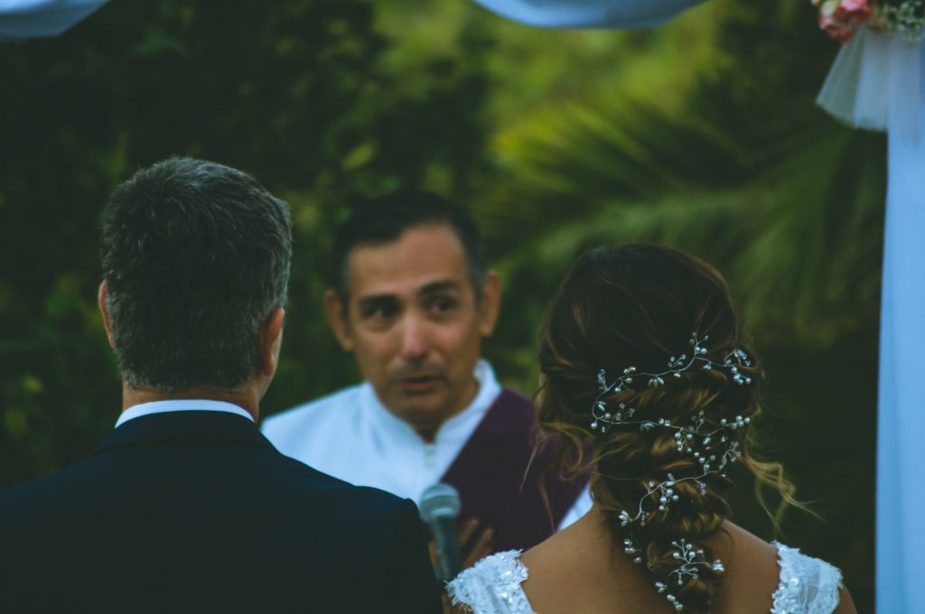 wedding officiant, bride and groom in a tropical location