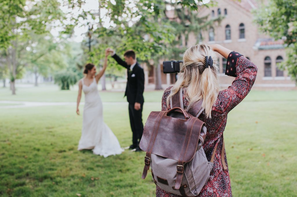 wedding photographer taking a photo of a bride and groom